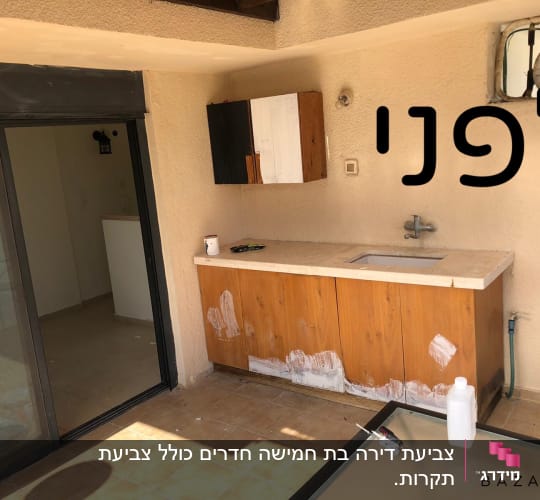 ארון עץ עם סימני צבע לבן, מברשת צבע על השולחן